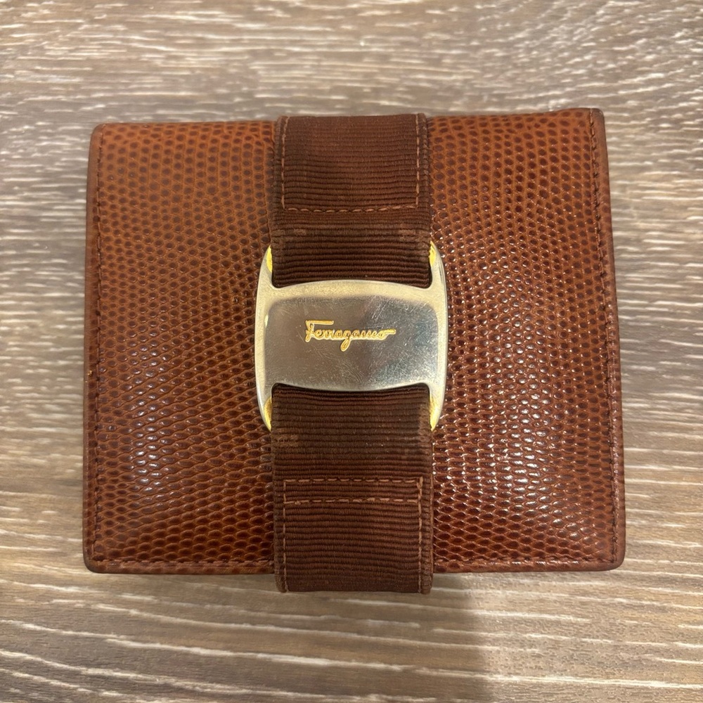 Ferragamo bifold wallet
Used condition 
No smell
See photos for tarnish and wear